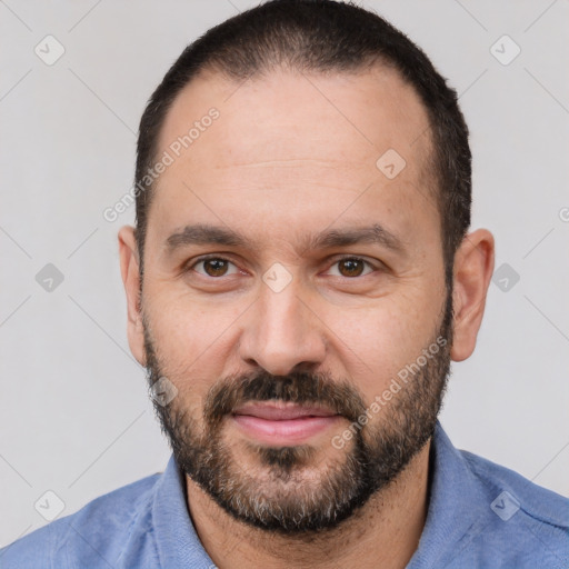 Joyful white adult male with short  black hair and brown eyes