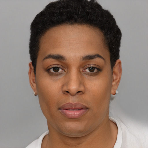 Joyful latino young-adult female with short  black hair and brown eyes