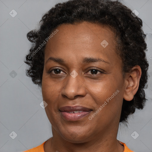 Joyful black adult female with short  brown hair and brown eyes