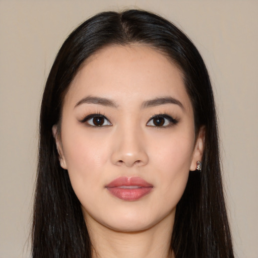 Joyful asian young-adult female with long  black hair and brown eyes