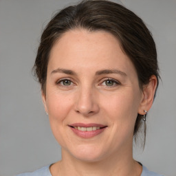 Joyful white adult female with medium  brown hair and grey eyes