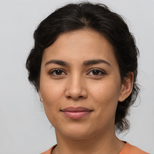 Joyful latino young-adult female with medium  brown hair and brown eyes