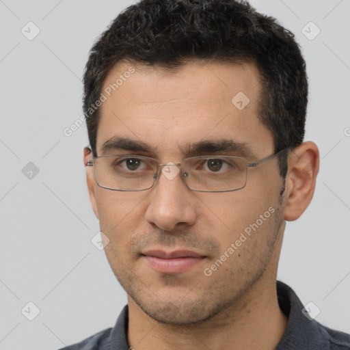 Joyful white young-adult male with short  black hair and brown eyes