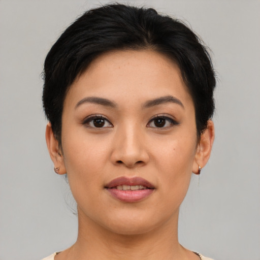 Joyful asian young-adult female with short  brown hair and brown eyes