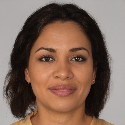 Joyful latino young-adult female with medium  brown hair and brown eyes