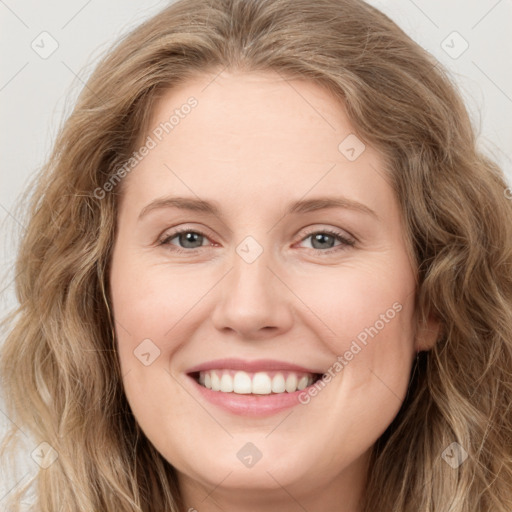 Joyful white young-adult female with long  brown hair and green eyes