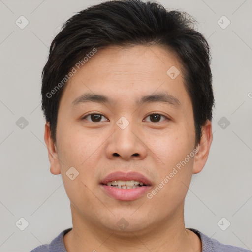 Joyful asian young-adult male with short  brown hair and brown eyes