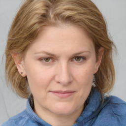 Joyful white young-adult female with medium  brown hair and blue eyes