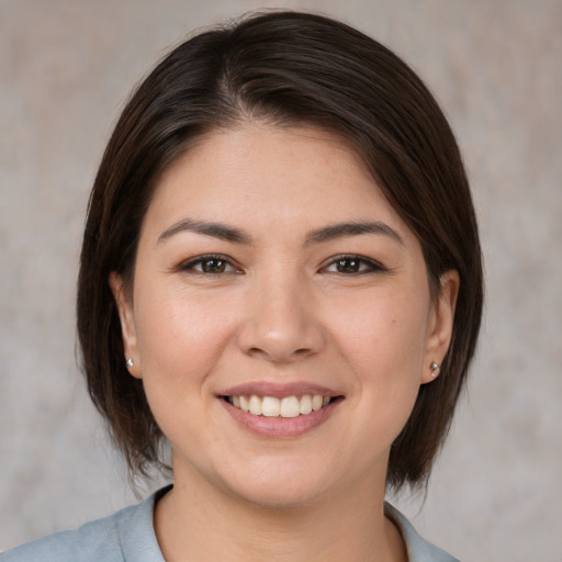 Joyful white young-adult female with medium  brown hair and brown eyes