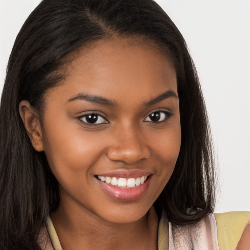 Joyful black young-adult female with long  brown hair and brown eyes