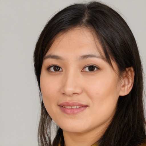 Joyful asian young-adult female with long  brown hair and brown eyes