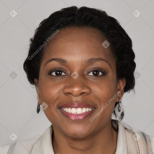 Joyful black adult female with medium  brown hair and brown eyes