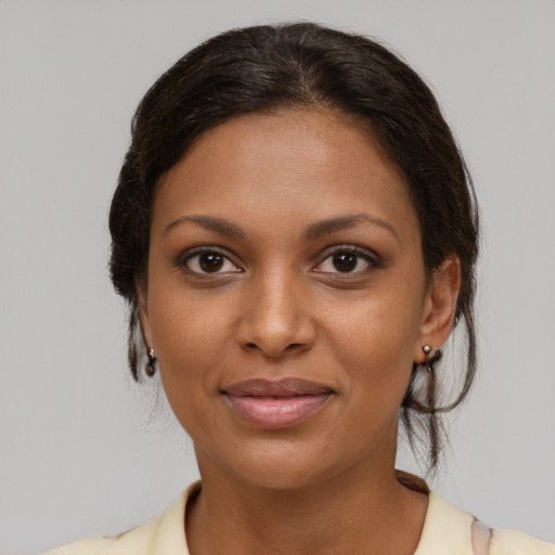 Joyful black young-adult female with medium  brown hair and brown eyes
