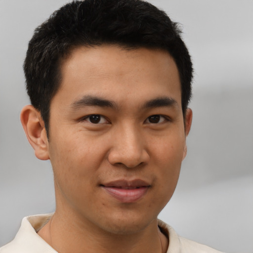 Joyful asian young-adult male with short  brown hair and brown eyes