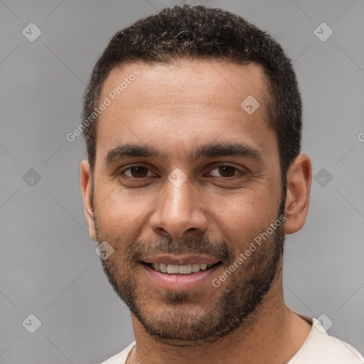 Joyful white young-adult male with short  black hair and brown eyes