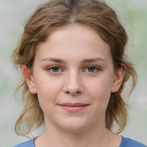 Joyful white child female with medium  brown hair and blue eyes