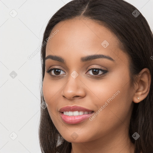 Joyful latino young-adult female with long  brown hair and brown eyes