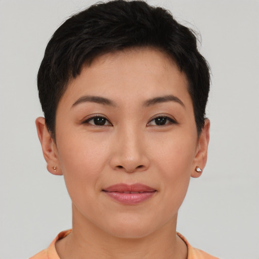 Joyful asian young-adult female with short  brown hair and brown eyes