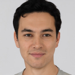 Joyful asian young-adult male with short  black hair and brown eyes