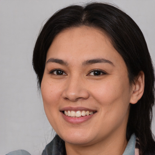 Joyful asian young-adult female with medium  brown hair and brown eyes