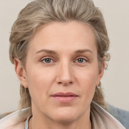 Joyful white adult female with medium  brown hair and grey eyes