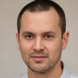 Joyful white adult male with short  brown hair and brown eyes