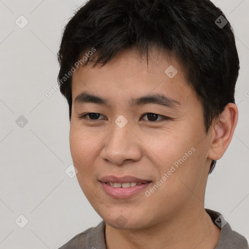 Joyful asian young-adult male with short  brown hair and brown eyes