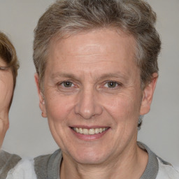 Joyful white middle-aged male with short  brown hair and brown eyes