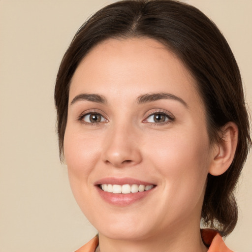 Joyful white young-adult female with medium  brown hair and brown eyes