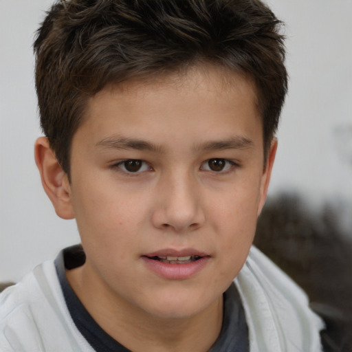 Joyful white child male with short  brown hair and brown eyes