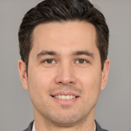 Joyful white young-adult male with short  brown hair and brown eyes