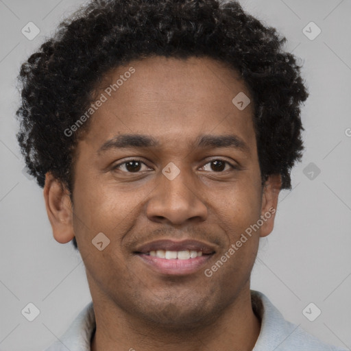 Joyful black young-adult male with short  brown hair and brown eyes