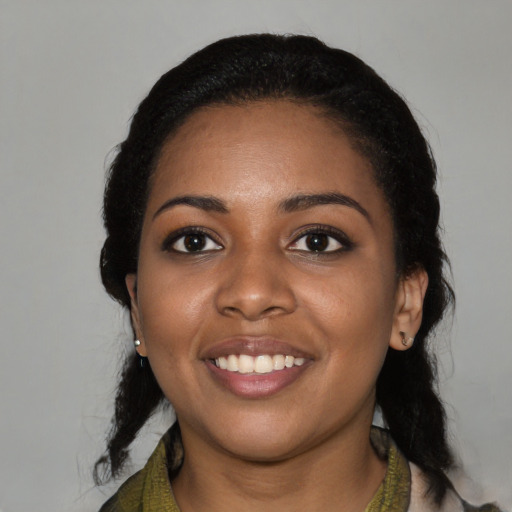Joyful black young-adult female with medium  black hair and brown eyes