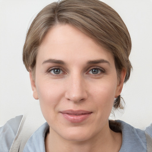 Joyful white young-adult female with medium  brown hair and grey eyes