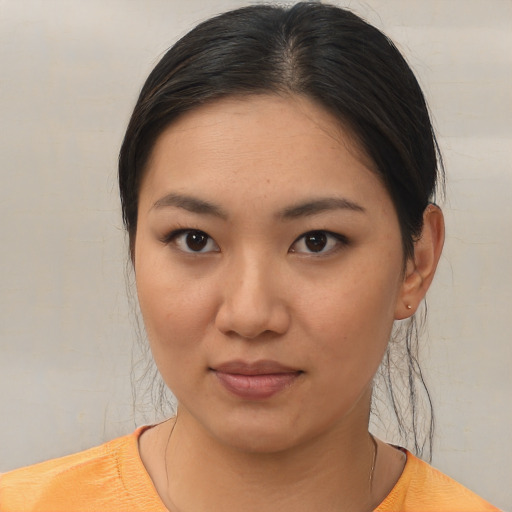 Joyful asian young-adult female with short  brown hair and brown eyes