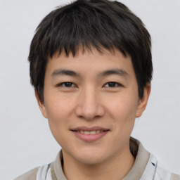 Joyful asian young-adult male with short  brown hair and brown eyes