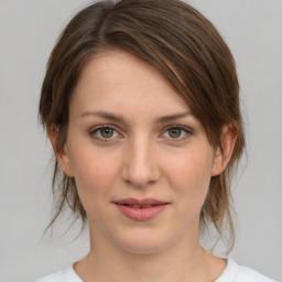 Joyful white young-adult female with medium  brown hair and green eyes