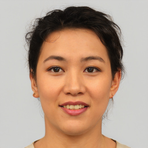Joyful asian young-adult female with medium  brown hair and brown eyes