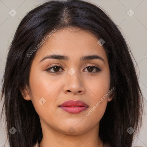 Joyful latino young-adult female with long  brown hair and brown eyes