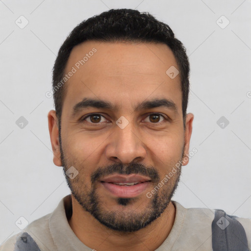 Joyful latino young-adult male with short  black hair and brown eyes