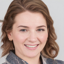 Joyful white young-adult female with medium  brown hair and blue eyes