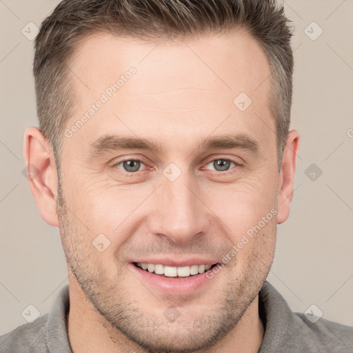 Joyful white adult male with short  brown hair and grey eyes