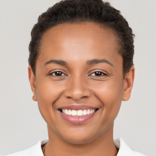 Joyful latino young-adult female with short  brown hair and brown eyes