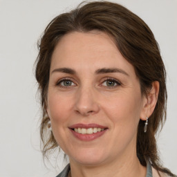 Joyful white adult female with medium  brown hair and brown eyes