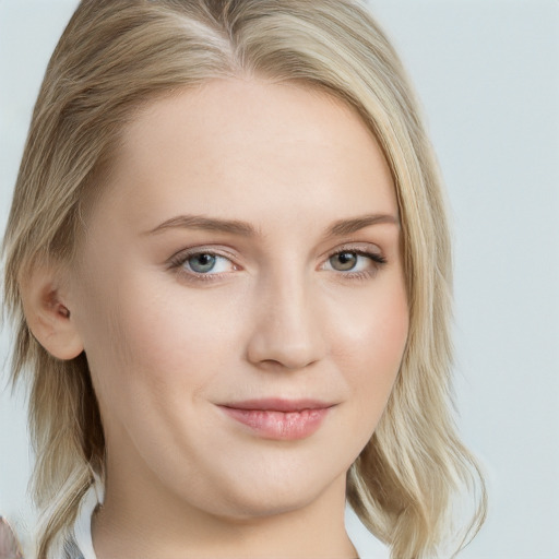 Joyful white young-adult female with long  brown hair and blue eyes