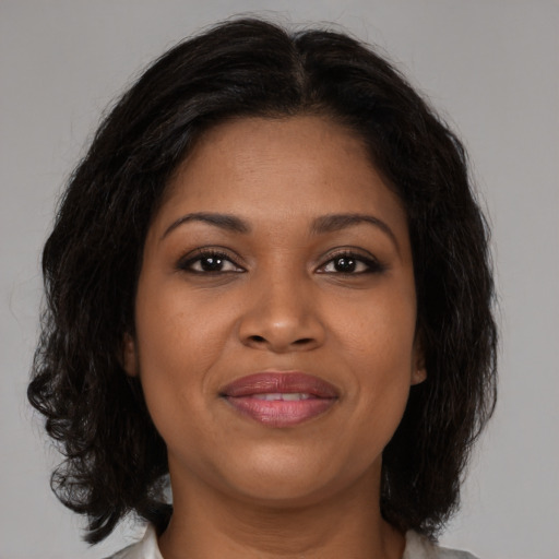 Joyful black young-adult female with medium  brown hair and brown eyes