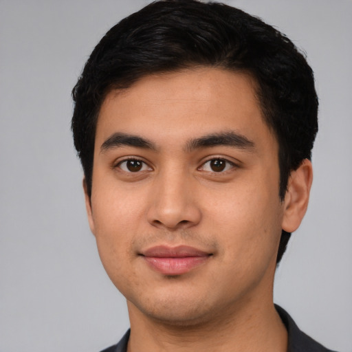 Joyful latino young-adult male with short  black hair and brown eyes