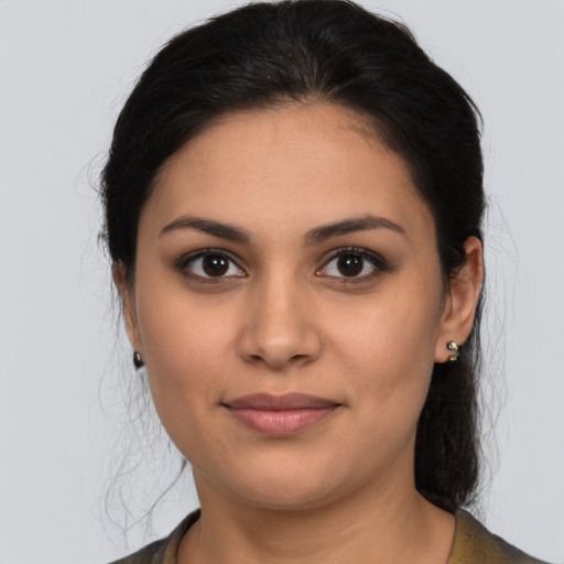 Joyful latino young-adult female with medium  brown hair and brown eyes