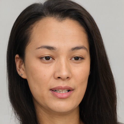 Joyful white young-adult female with long  brown hair and brown eyes