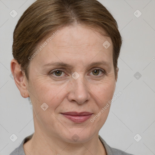 Joyful white adult female with short  brown hair and grey eyes